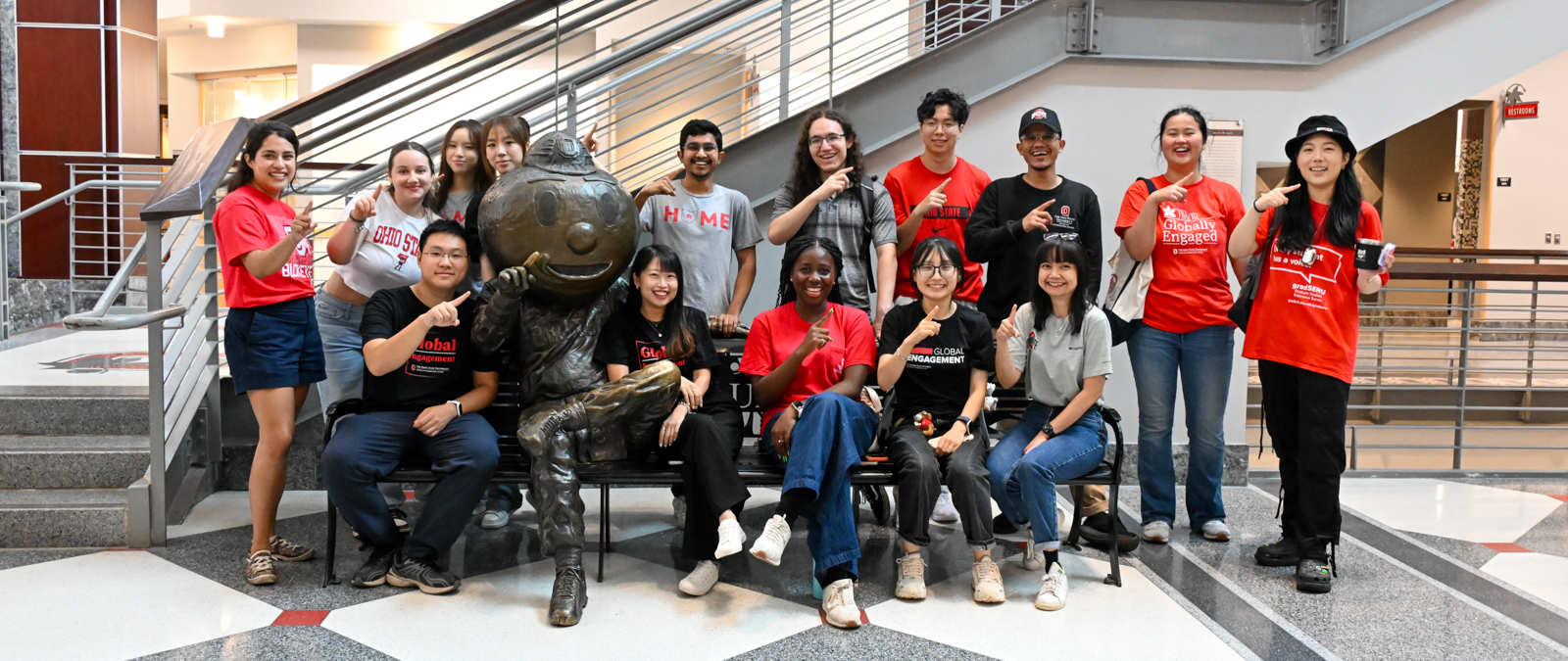 Group of students posing with Brutus statue at the Ohio Union at Ohio State.