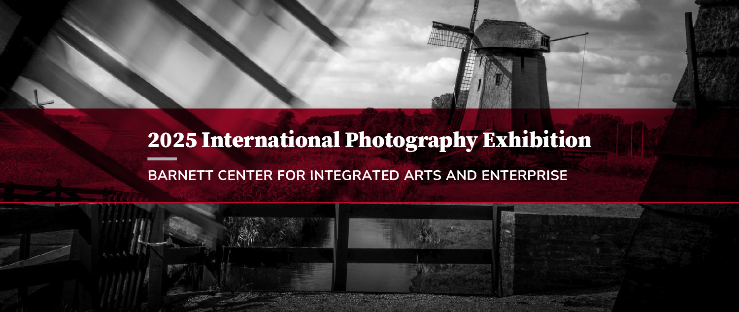 Banner for the 2025 International Photography Exhibition at the Barnett Center for Integrated Arts and Enterprise, featuring a stylized black and red image of a windmill and cloudy sky.