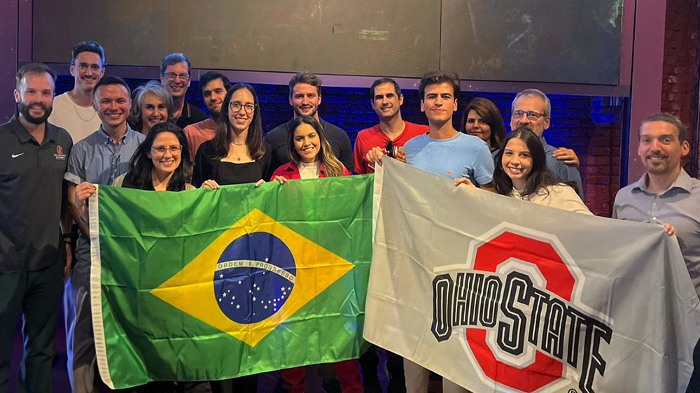 Brazil Gateway employees holding an Ohio State and Brazil Flag