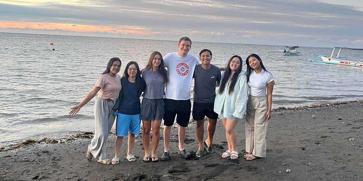 students posing on a beach in Bali