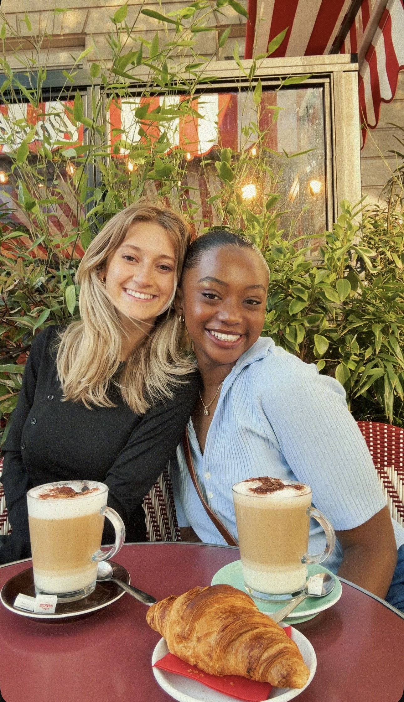 Two women sitting by coffee
