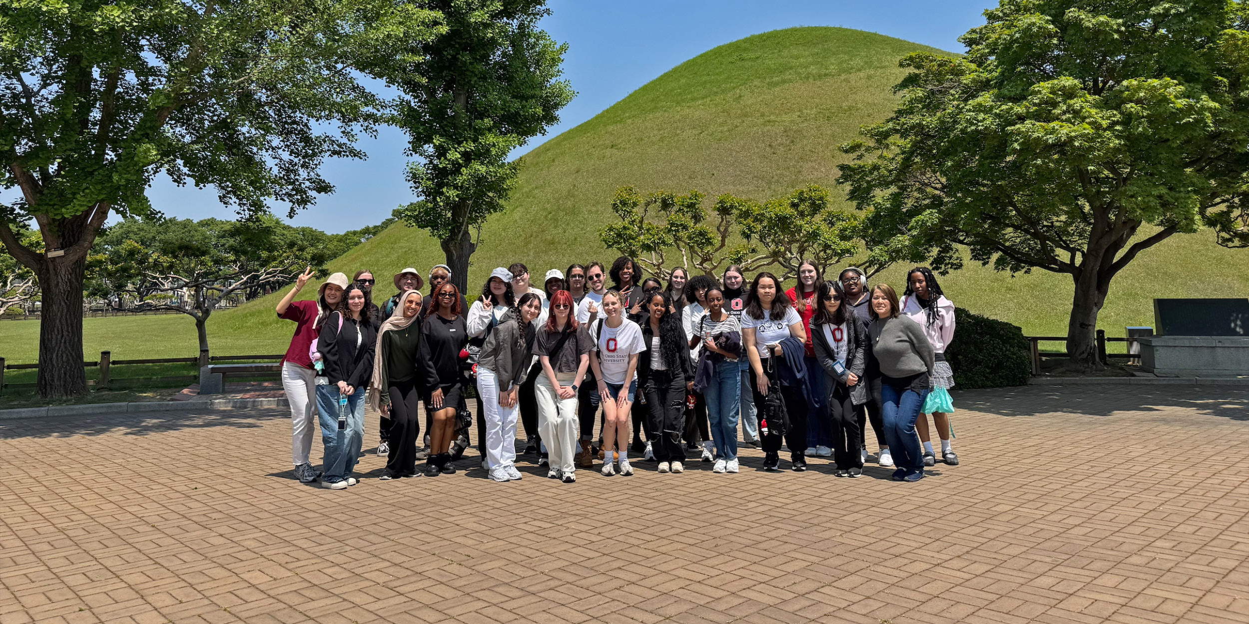 students with mound in the background in Korea