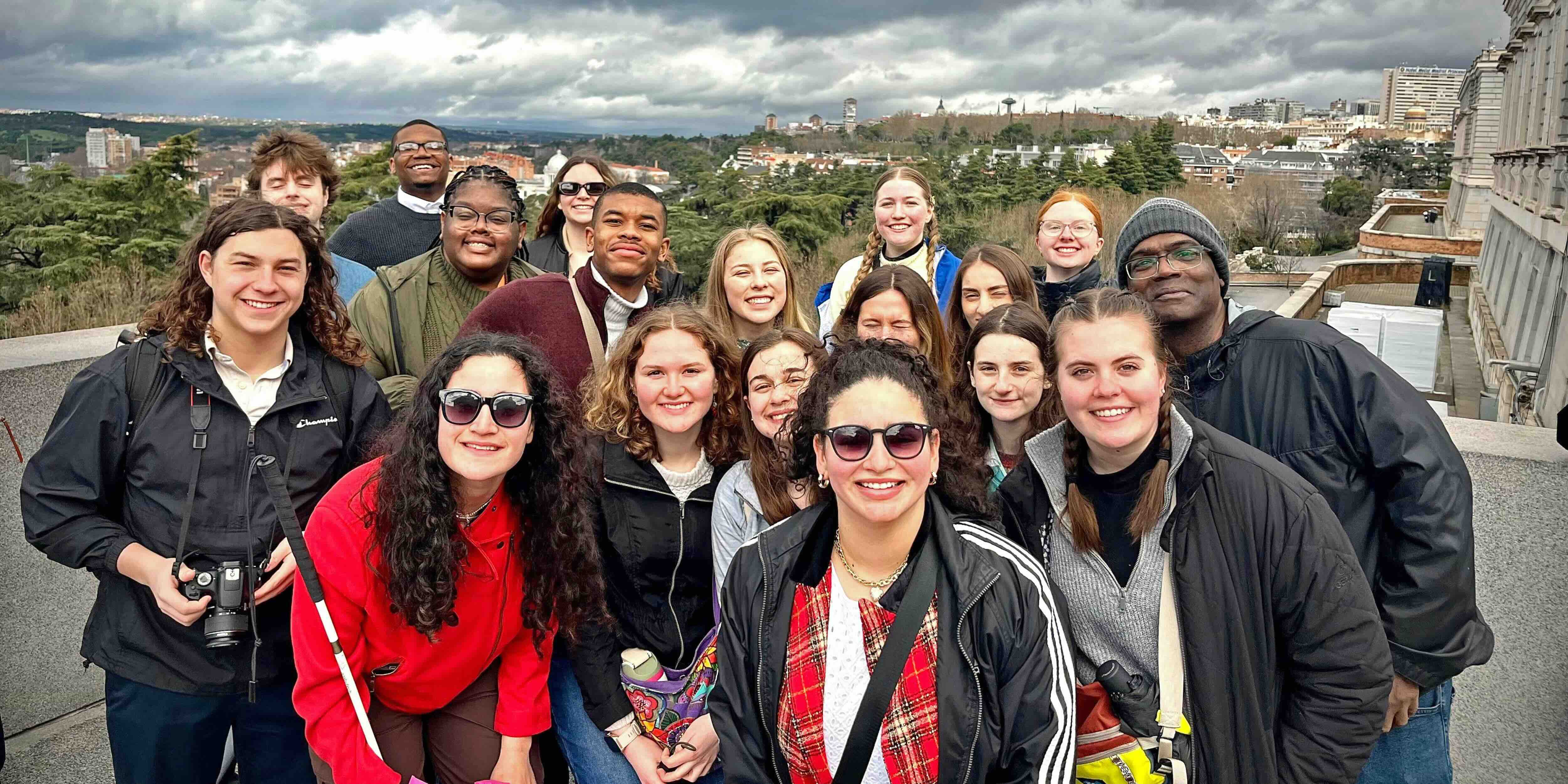 students and staff posing overlooking a city