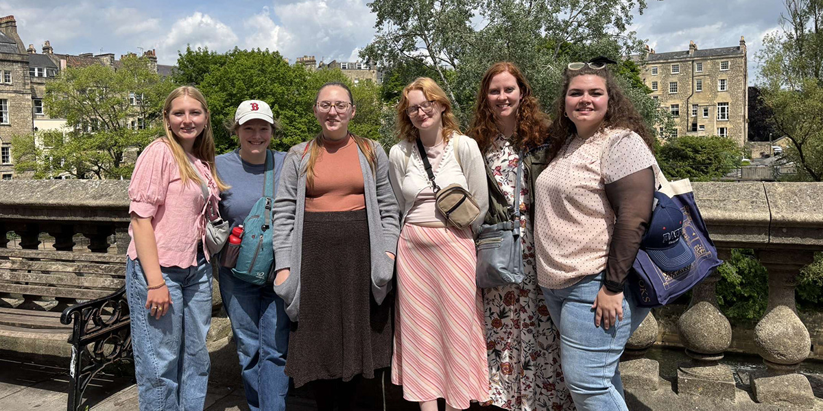 students posing on a bridge