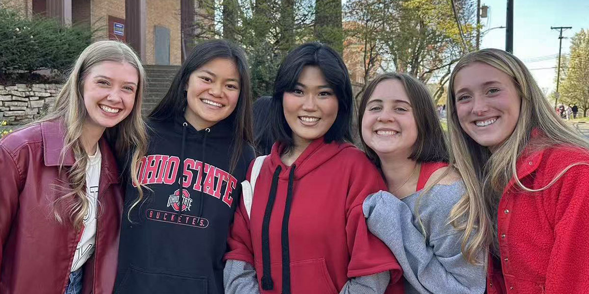Yiran Wang (middle) with friends in OSU attire