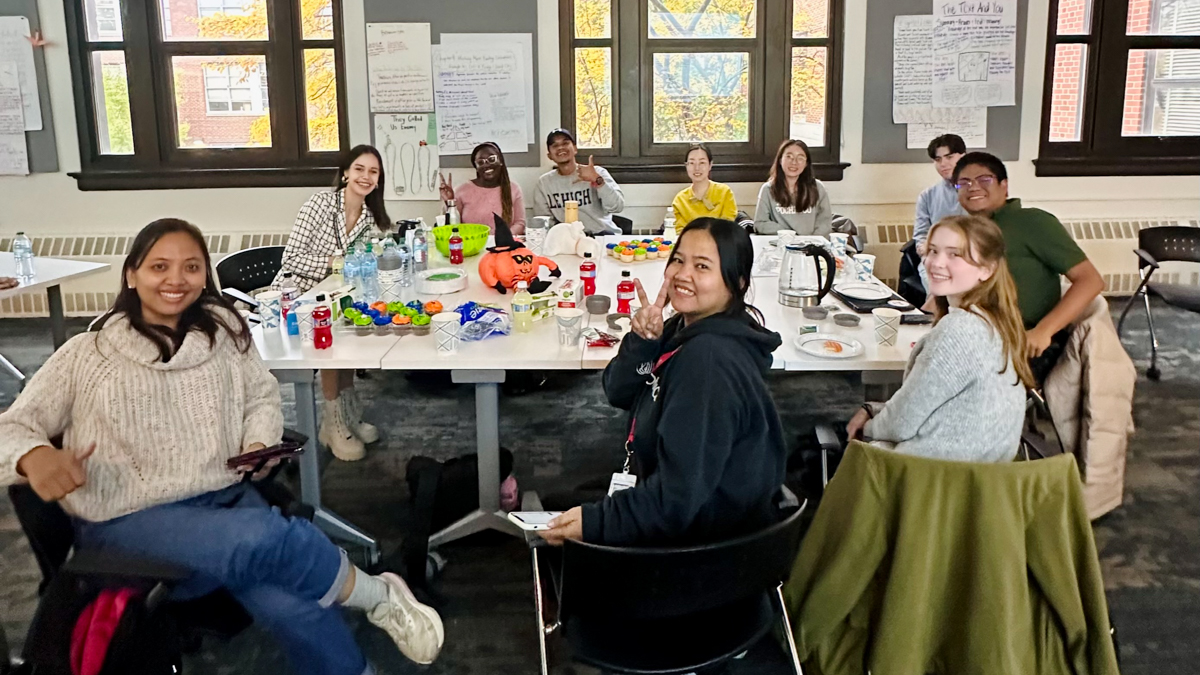 Students at desks and tables in classroom.