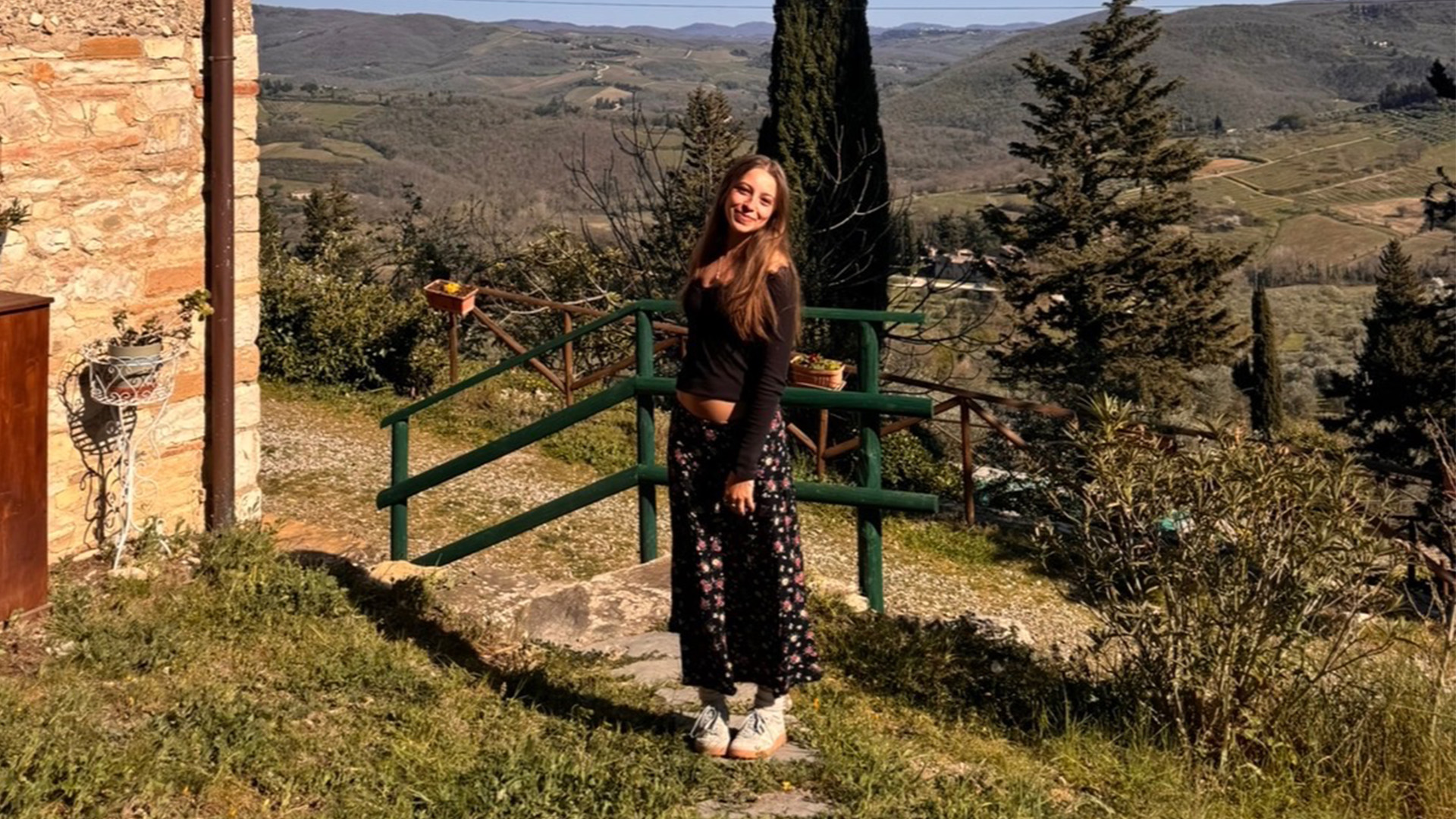 Student posing on an Italian countryside