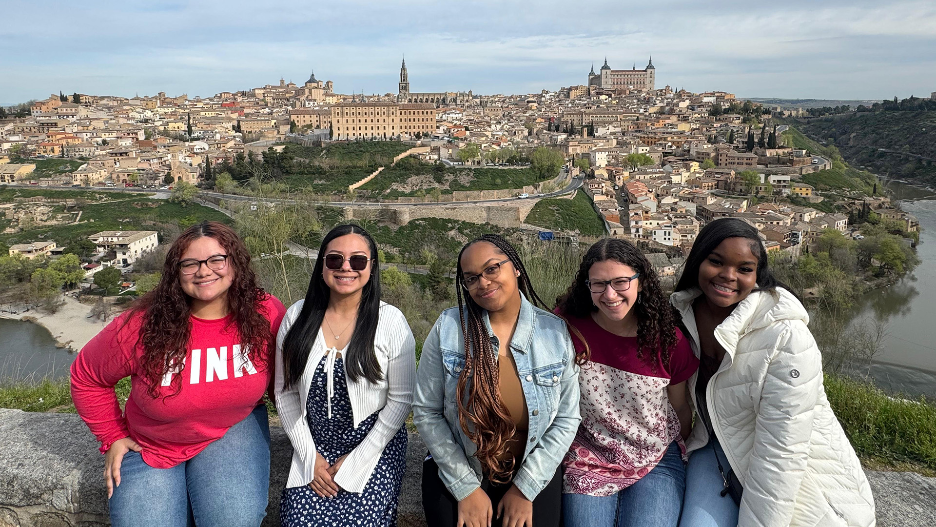 Students posing over a landscape