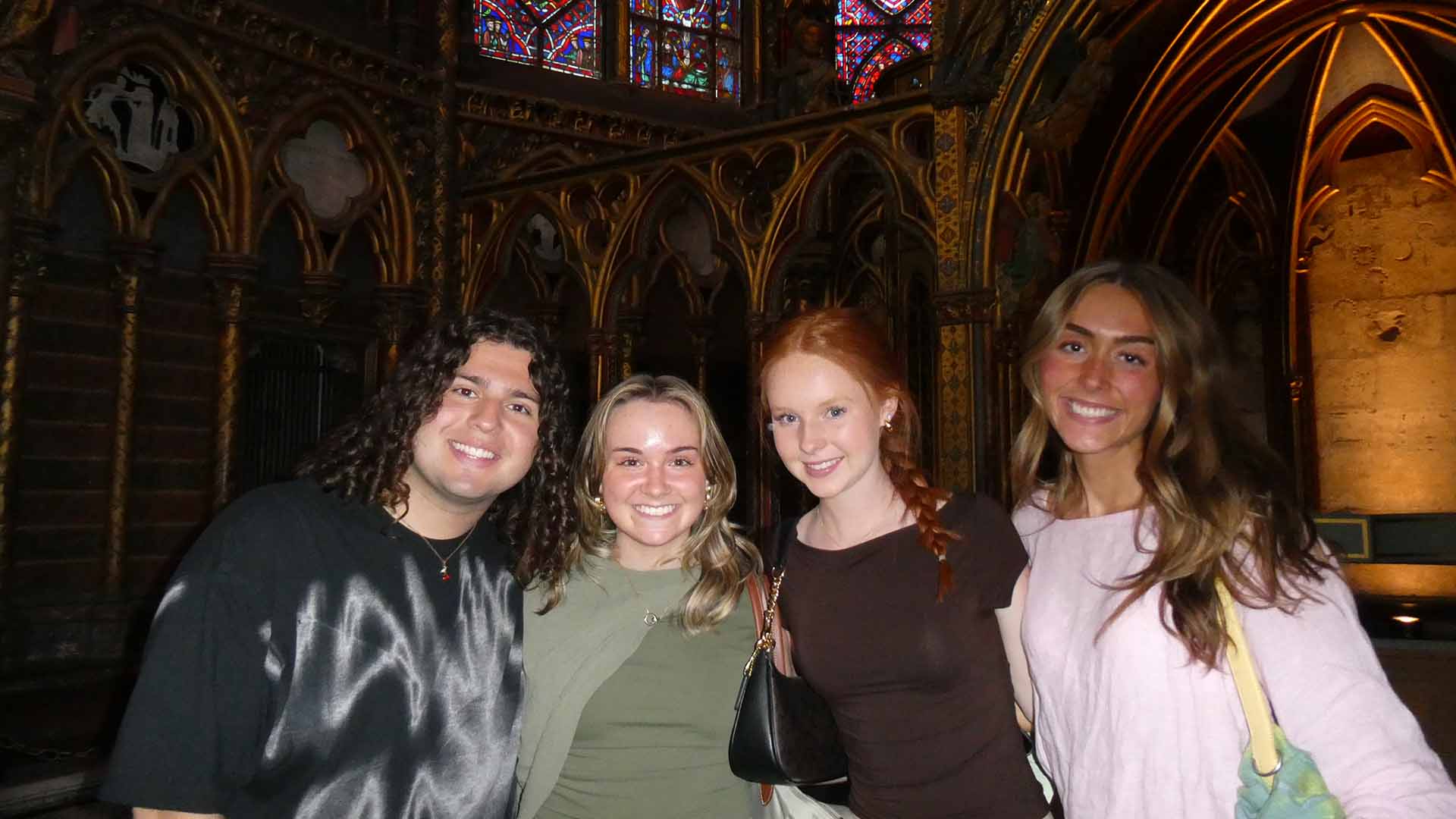 Students posing in a dark church