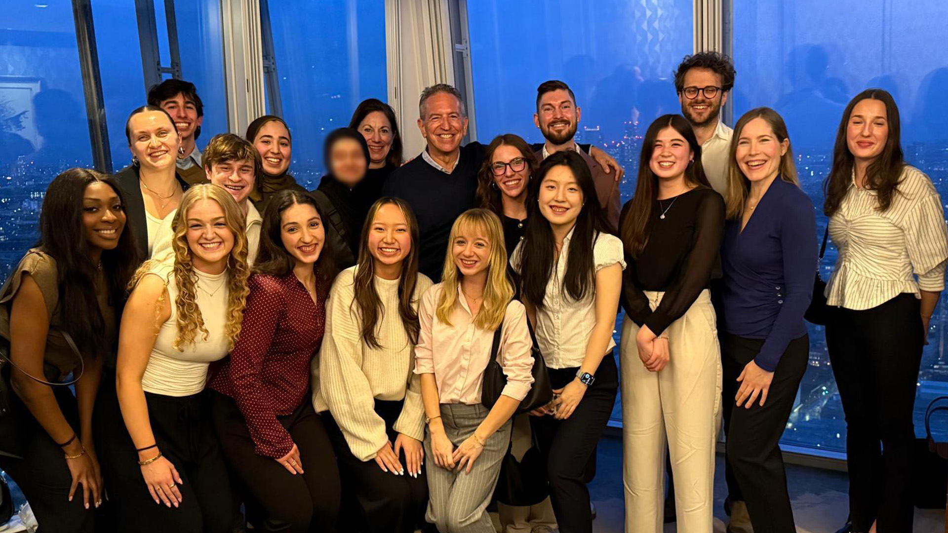 students posing near a window