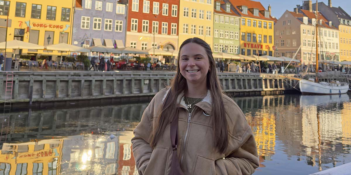 person overlooking river and buildings