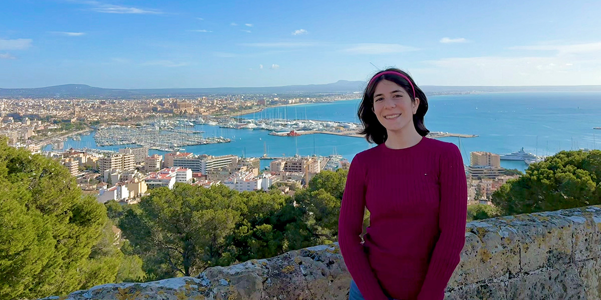 Student on a bridge overlooking city
