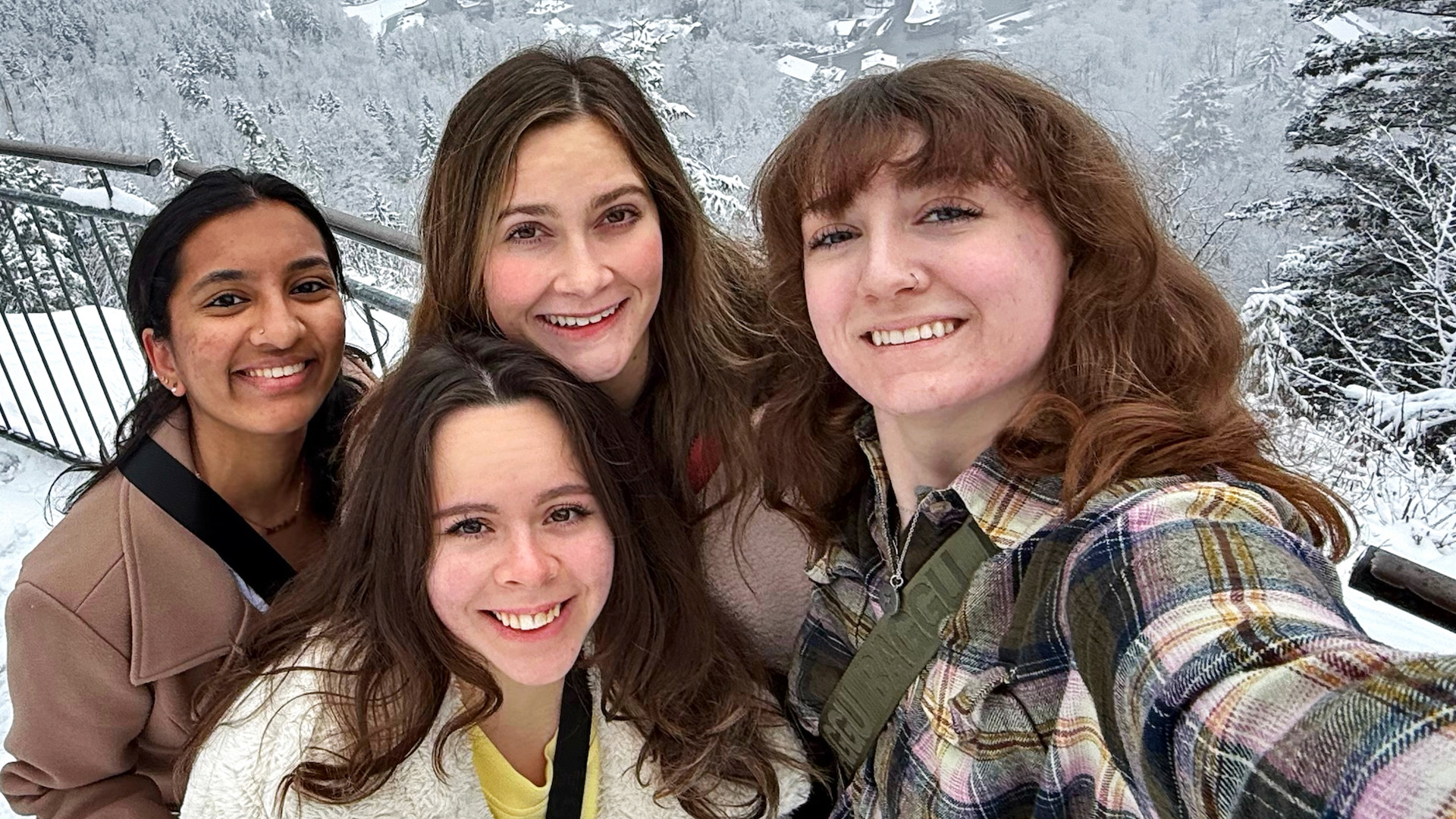 students posing on a snowy mountaintop
