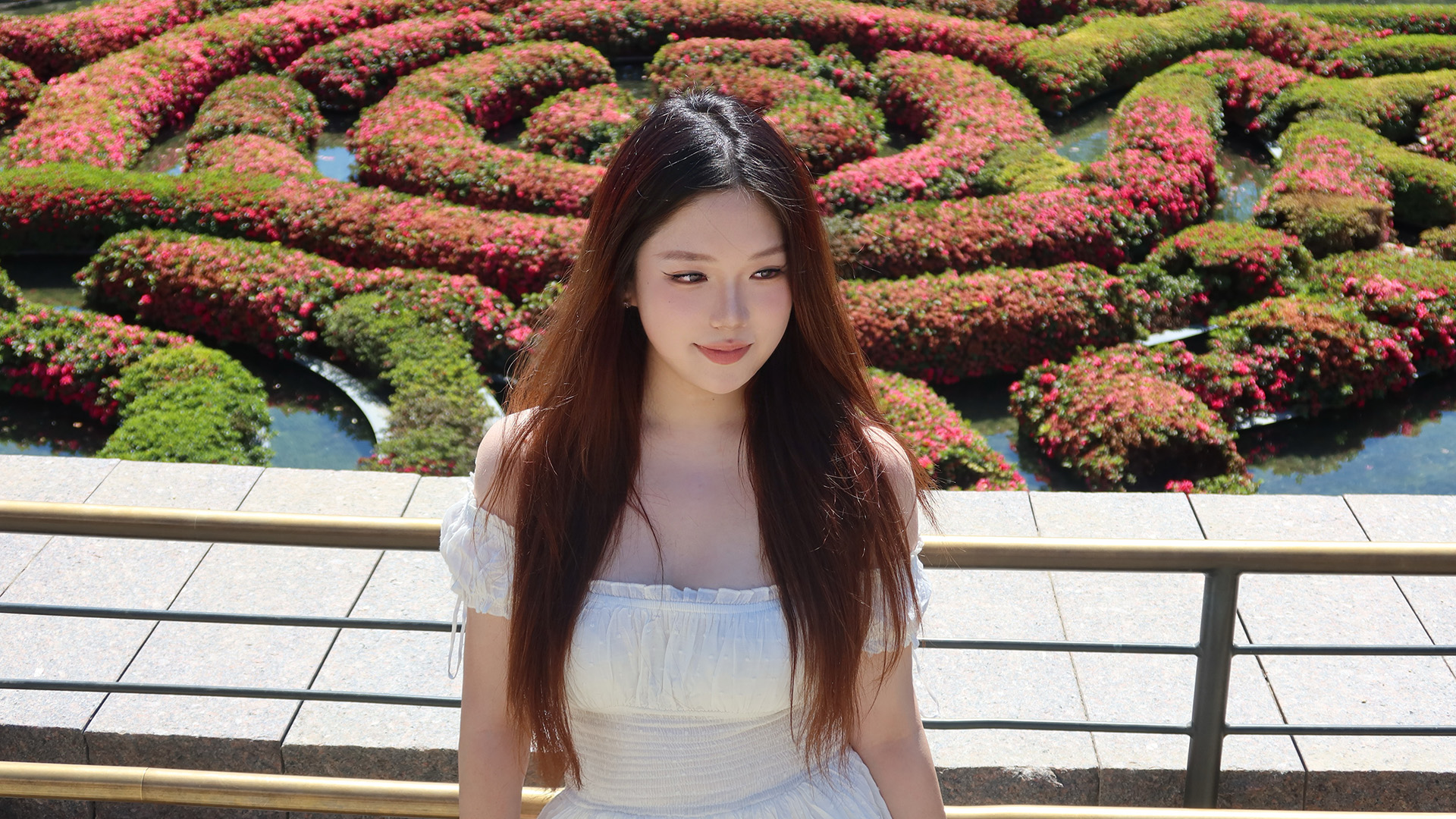 Student at park with lush shrubbery