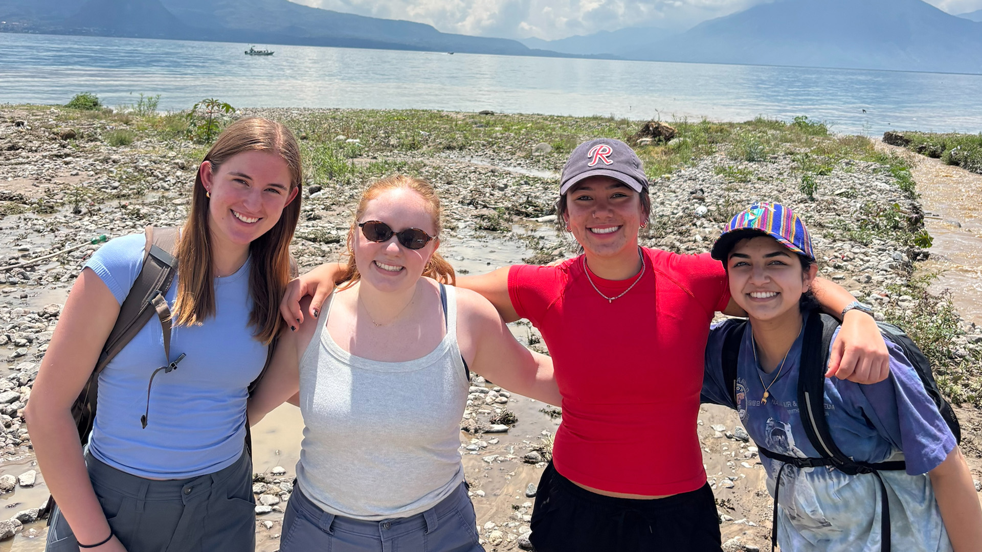 Students posing near a lake