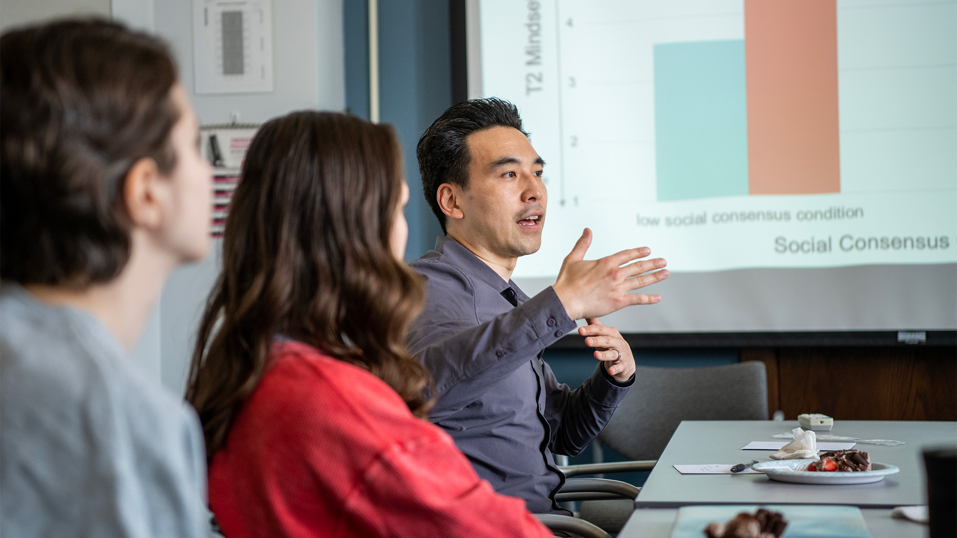 Psychology professor lectures students in a conference room