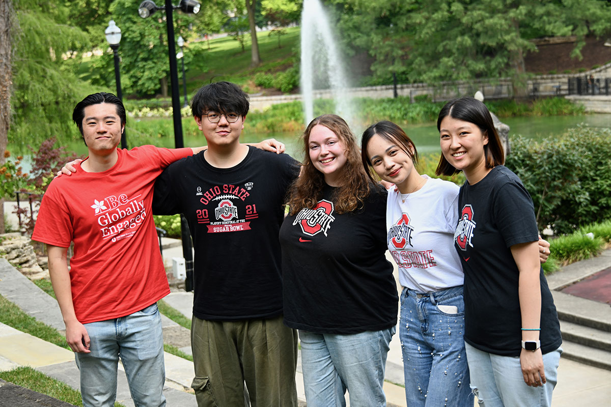 International students pose in front of Mirror Lake