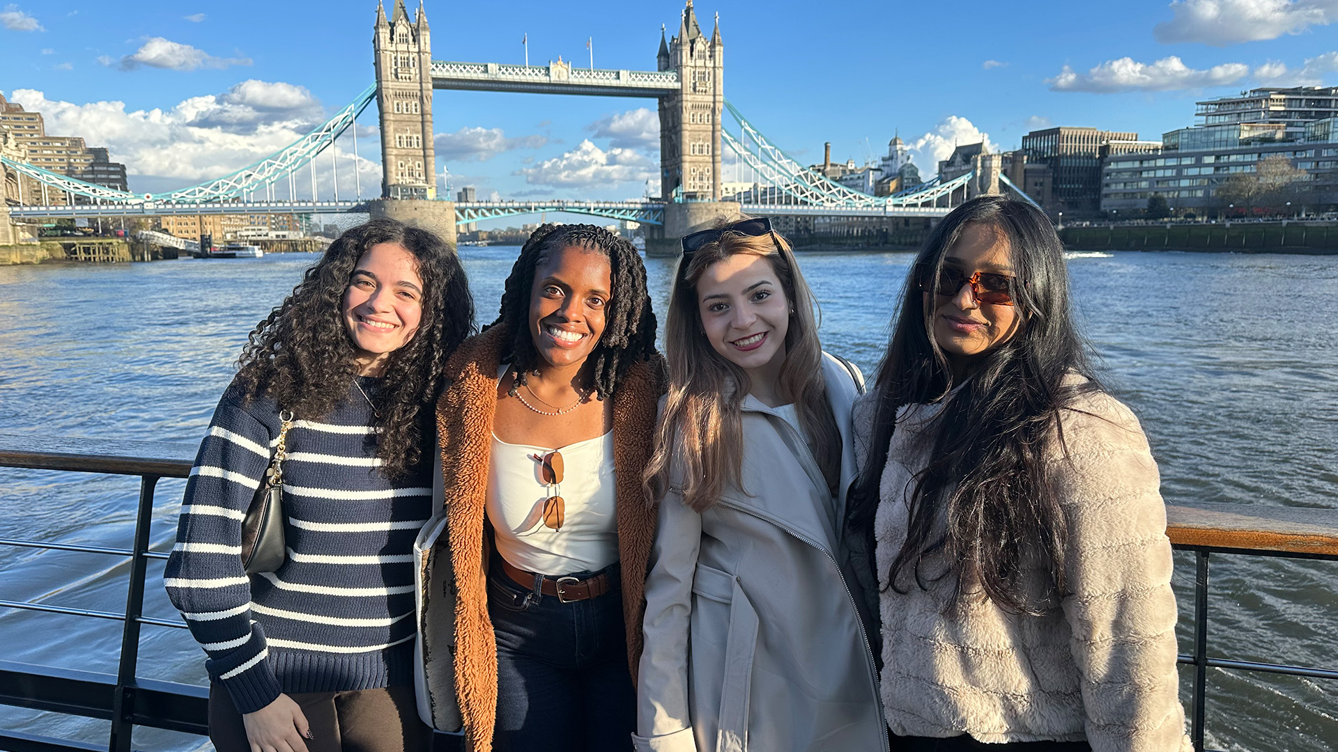 students posing with London Bridge in the background