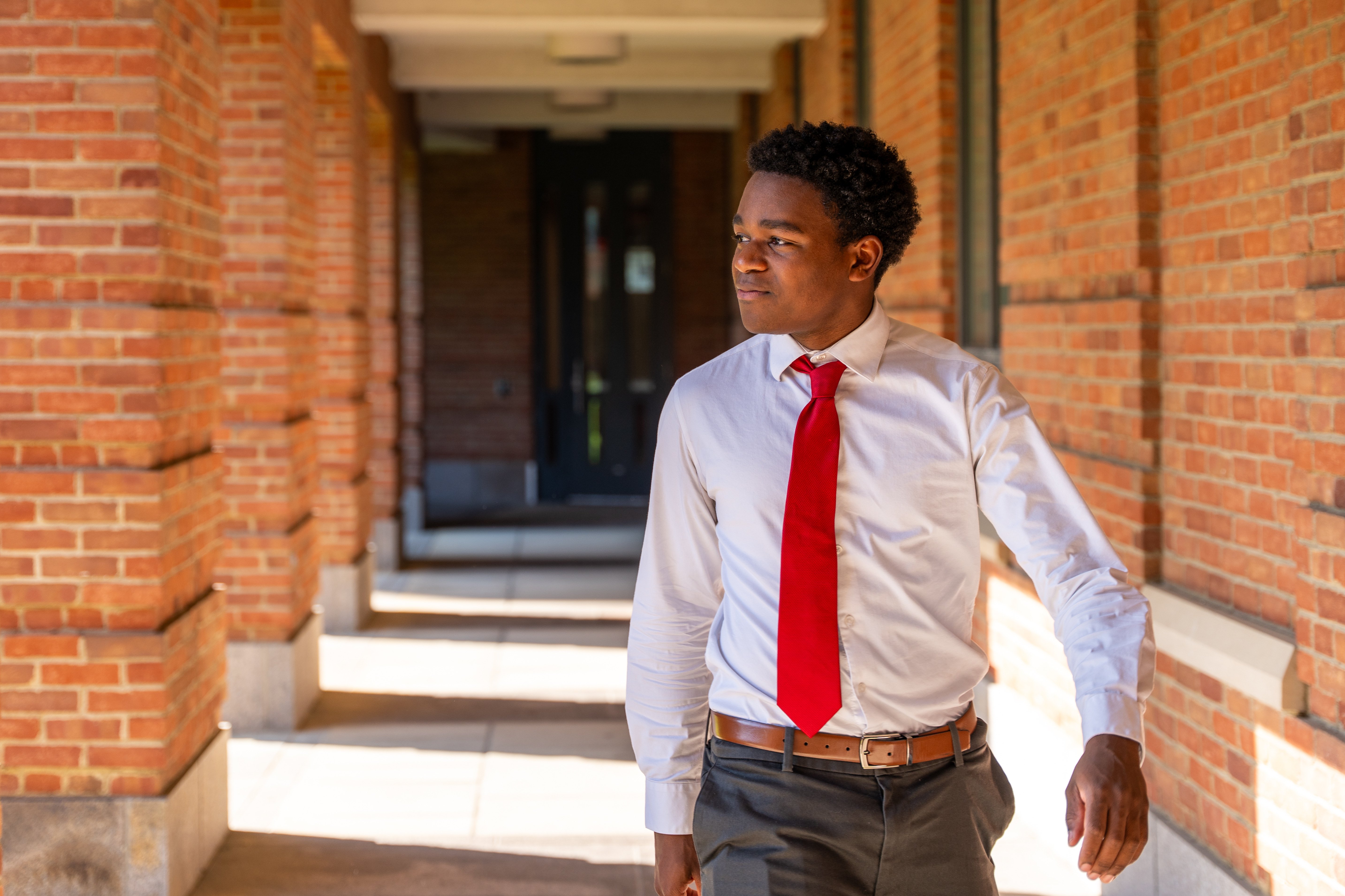Student walking along Fisher Corridor