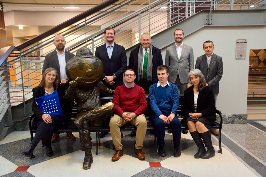 Delegation from Belgrade sitting on the Brutus Buckeye bench with Angela Britlinger