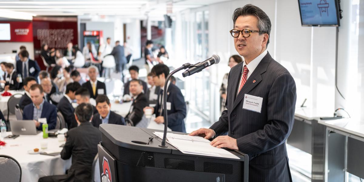 Man speaks at conference podium