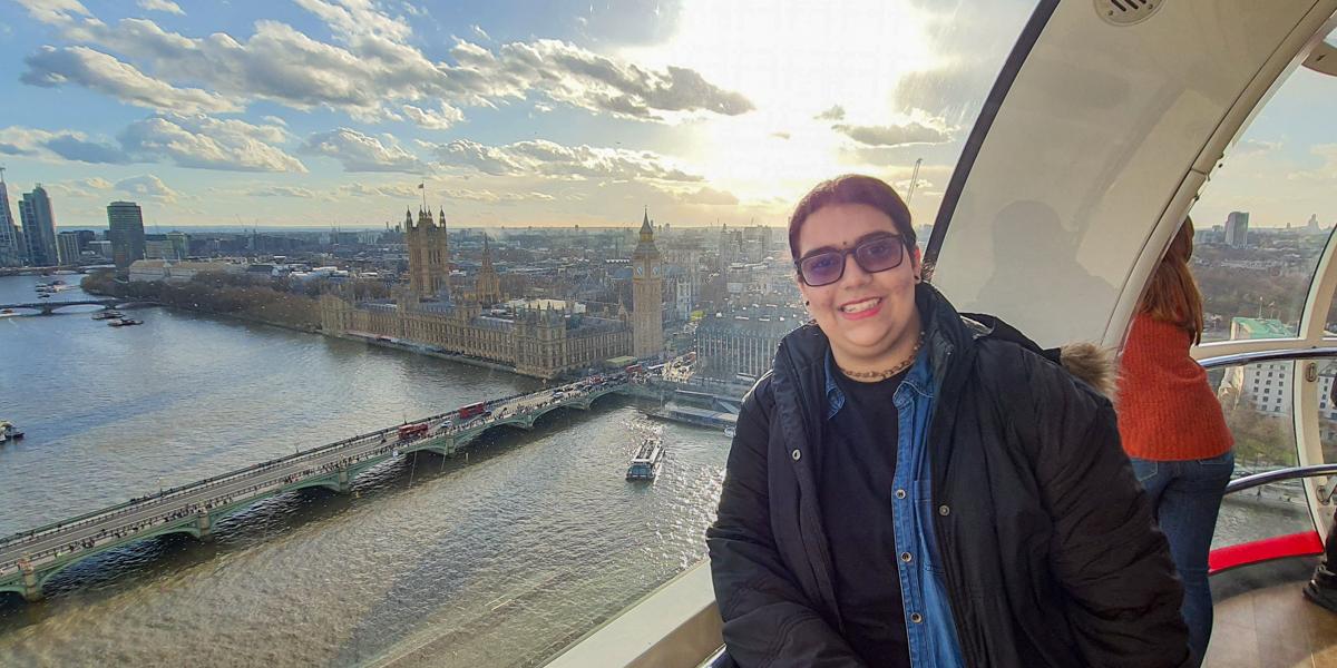 Woman in ferris wheel above London.