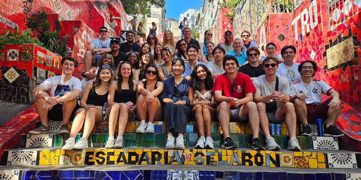 Large group of students sitting on colorful steps