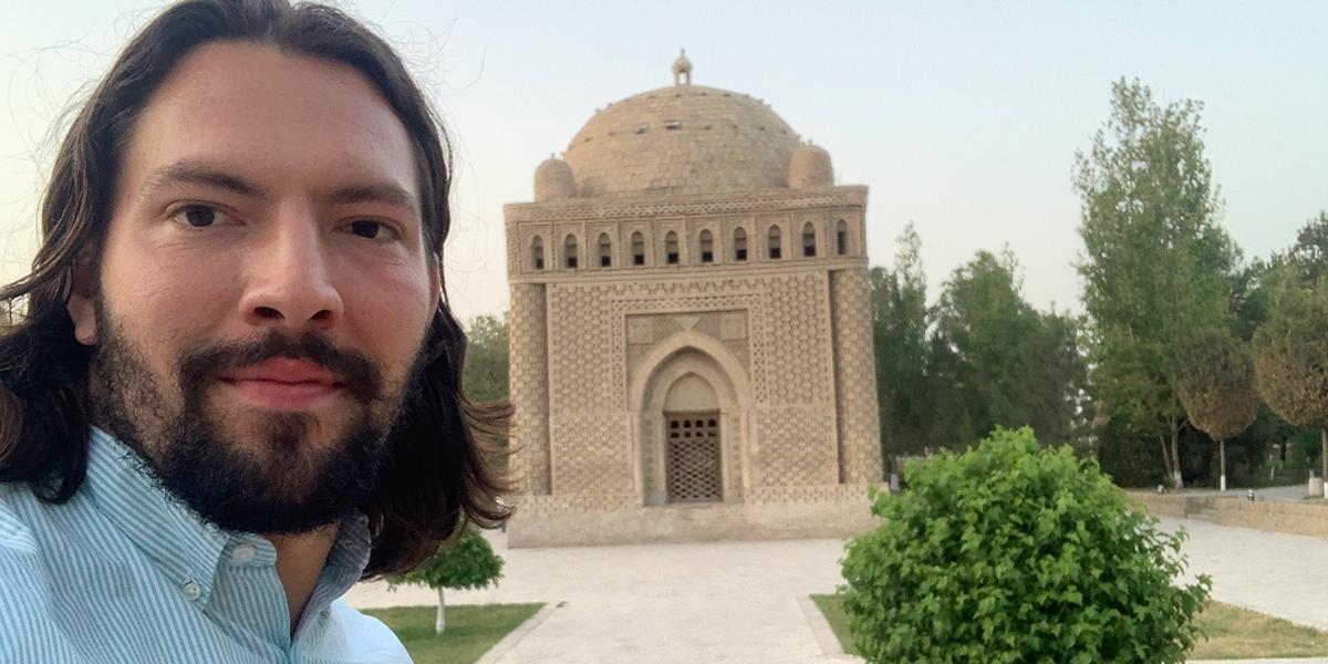 Selfie of male in front of temple.