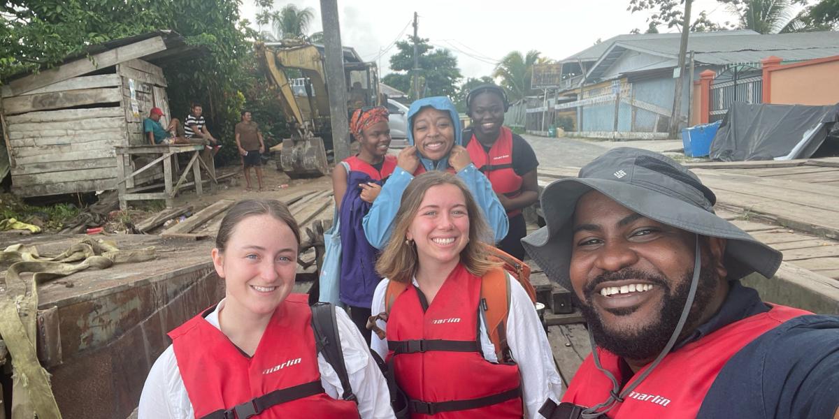 Students pose in life jackets in a Guyanan village
