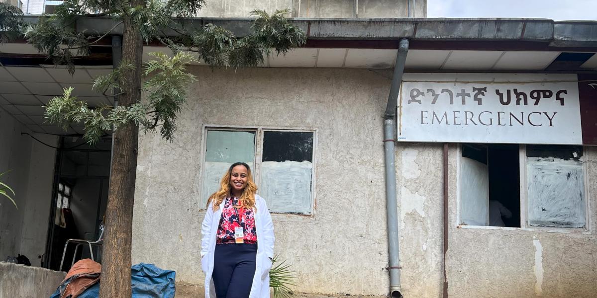 Young female doctor poses in front of an Ethiopian hospital