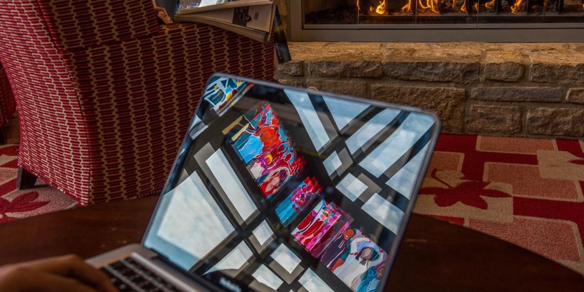 student studying with laptop in front of fireplace in Ohio Union.