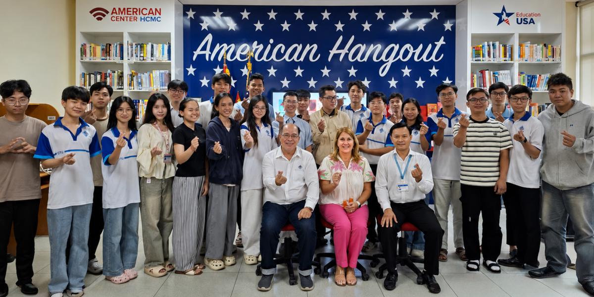 Large group of people with American Hangout banner on wall.