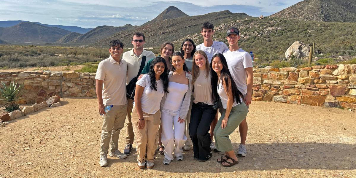 group of students with mountains in the background