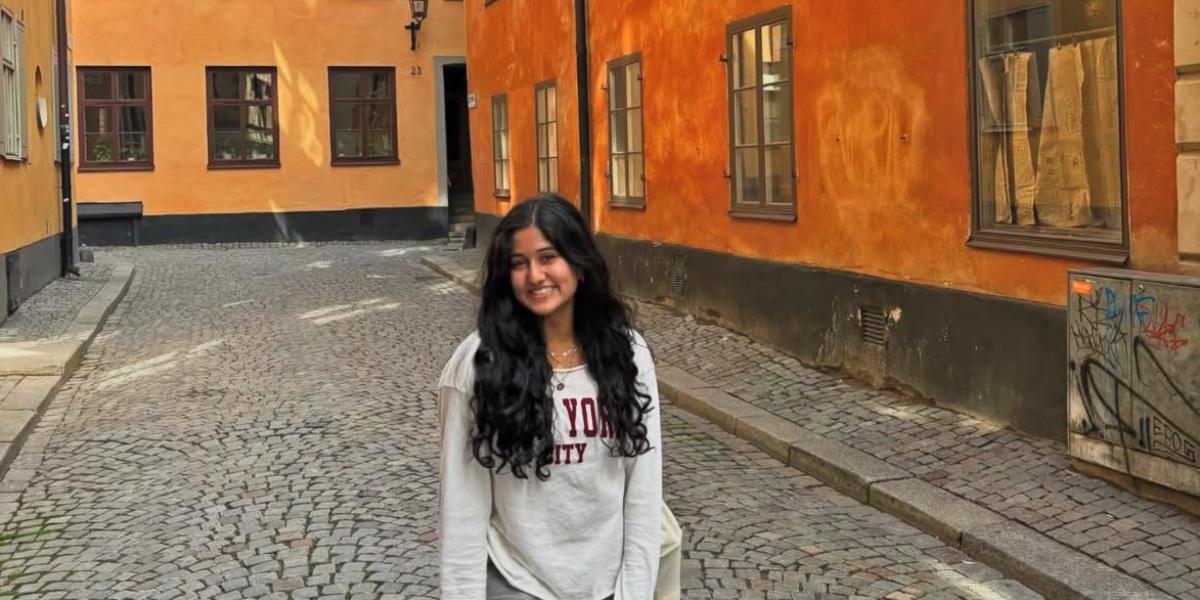 student posing in the street