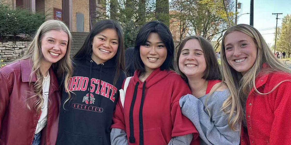 Yiran Wang (middle) with friends in OSU attire