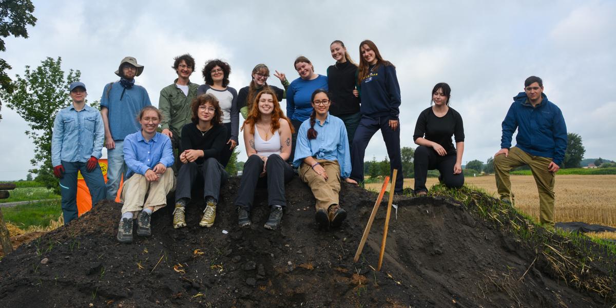 Group of students on a dirt mound