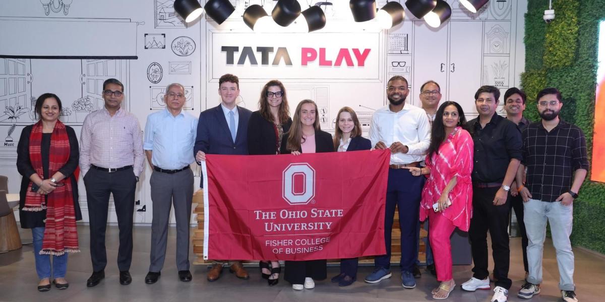 Group holding Ohio State flag at Tata Play office