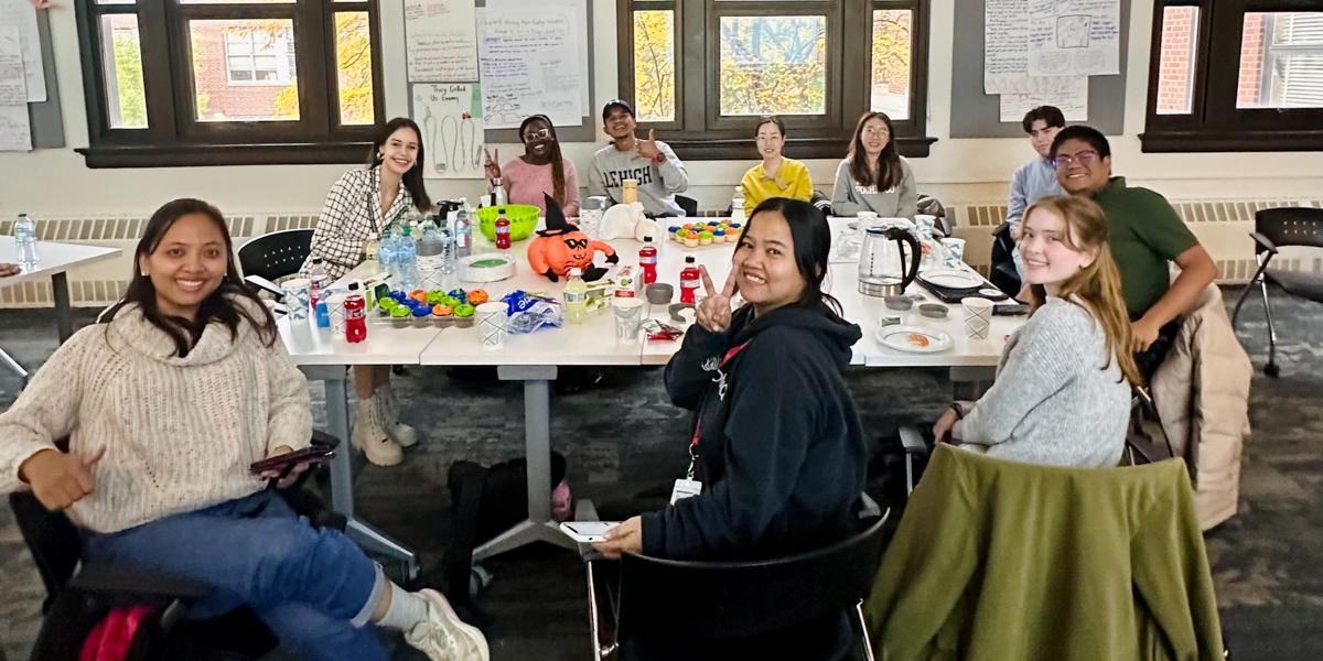 Students at desks and tables in classroom.