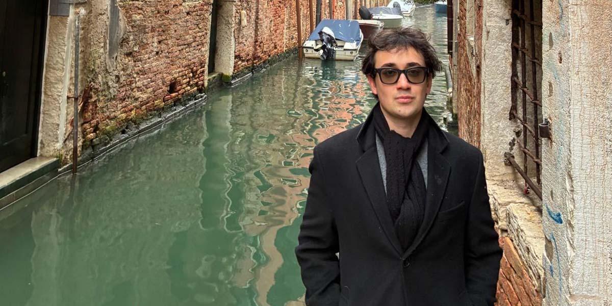 Student posing near canal