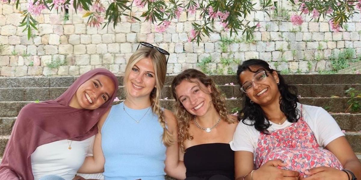 Students posing on a bench