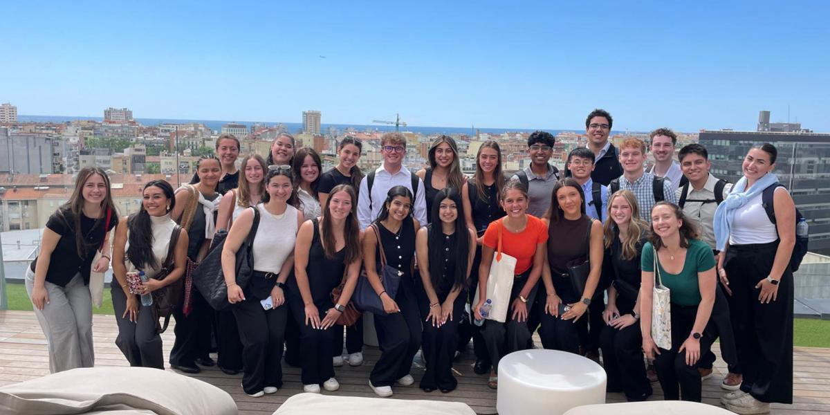 Students in formal attire on rooftop