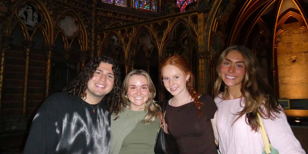 Students posing in a dark church