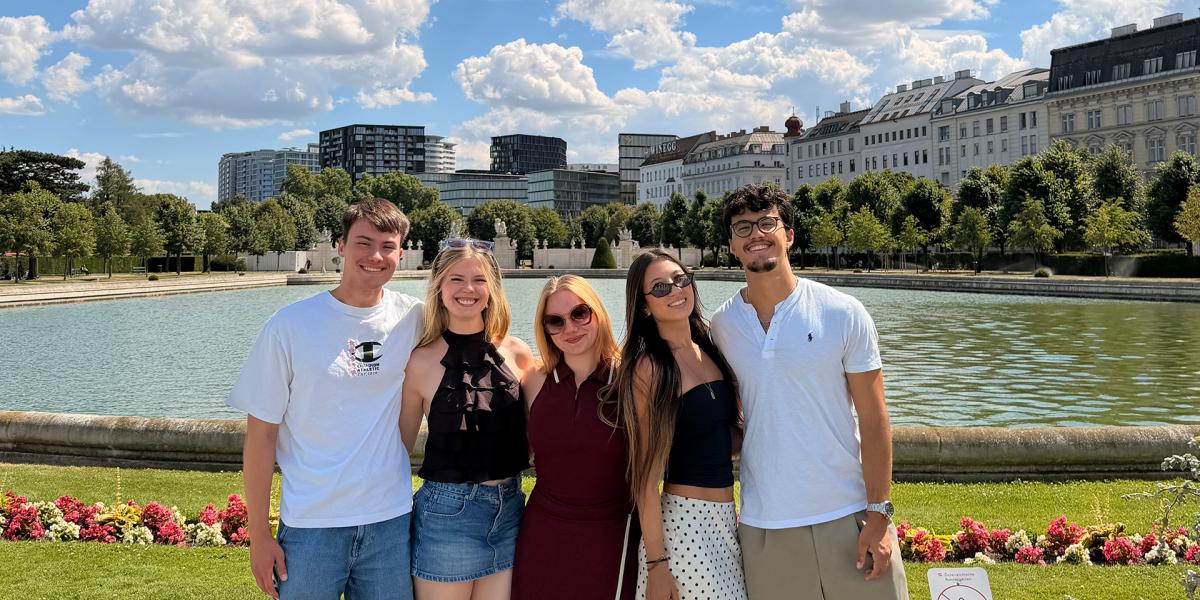 Students overlooking body of water