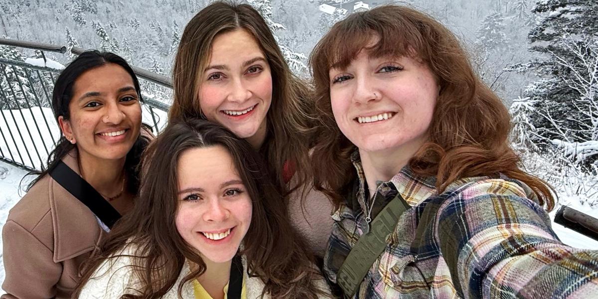 students posing on a snowy mountaintop
