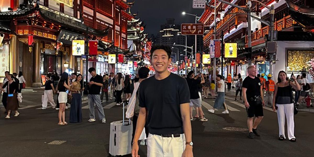 Student in busy street in China