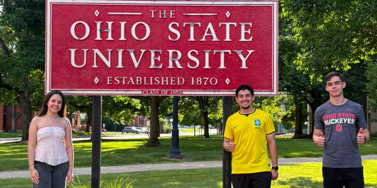 Students standing near Ohio State sign