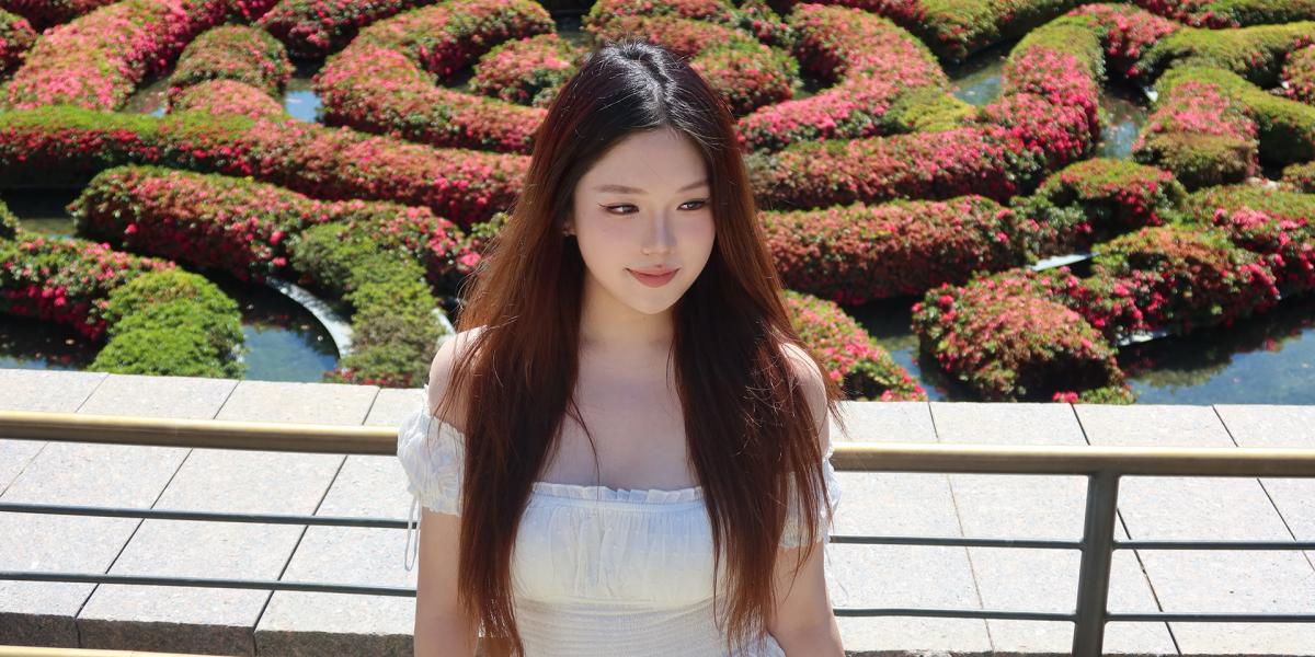 Student at park with lush shrubbery