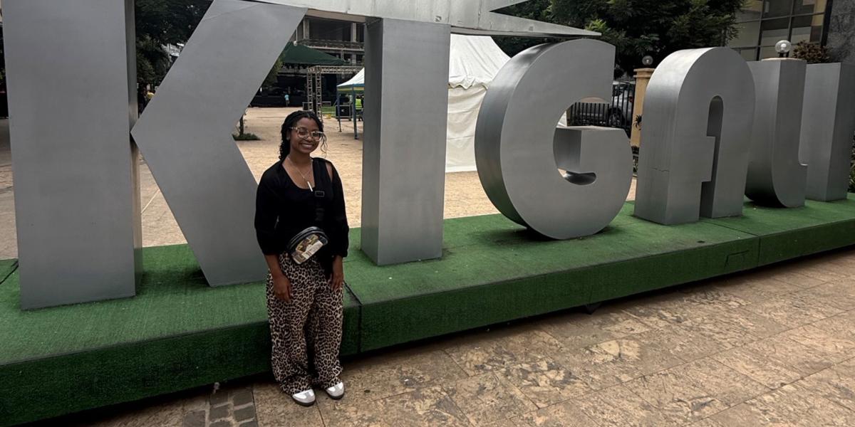 Student in front of medal sign