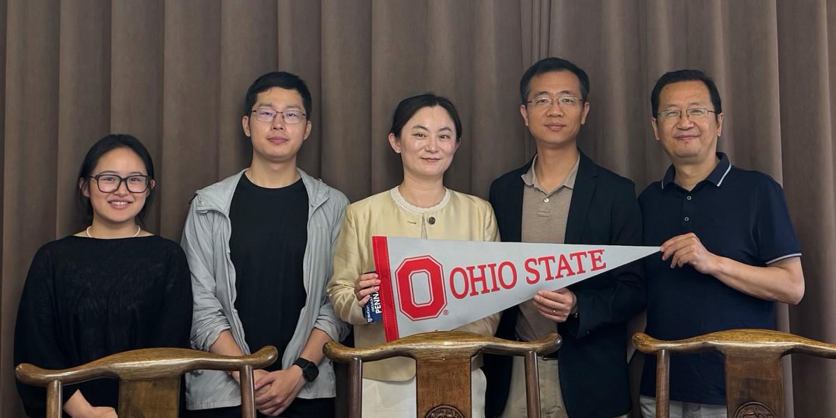 People holding an Ohio State pennant