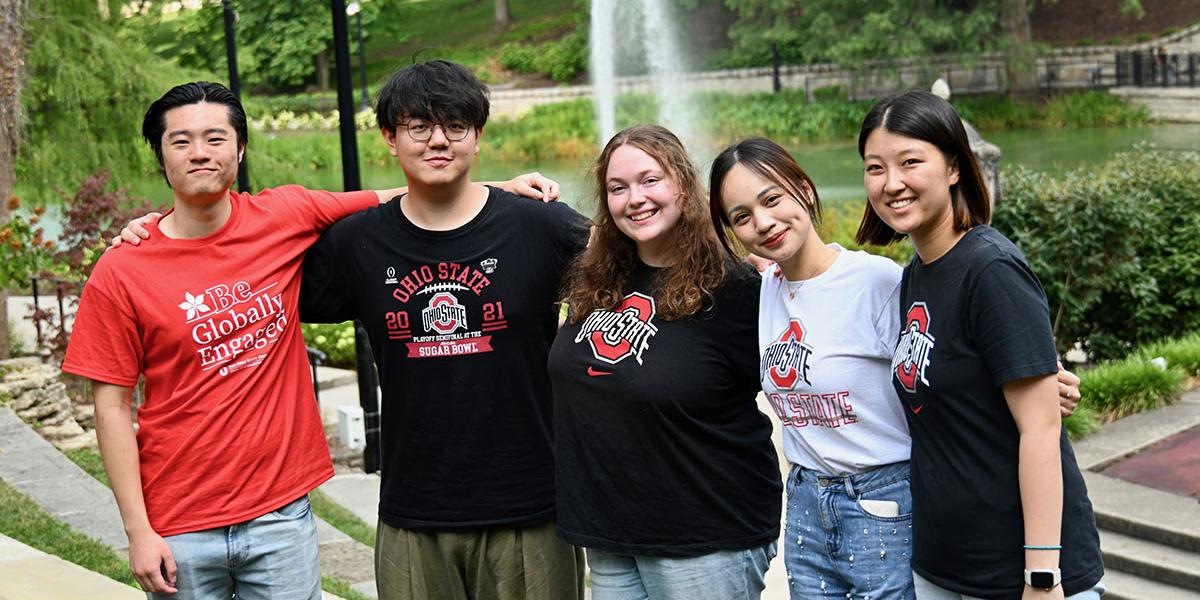 International students pose in front of Mirror Lake